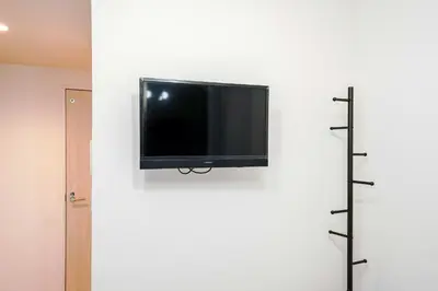 a flat screen tv hanging on a wall at B31\u6c60\u888b\u6700\u4e2d\u5fc3 \u4ea4\u901a\u4fbf\u5229\u8f66\u7ad93\u5206 Ikebukuro center 3 mins to ST Max 4P \u76f4\u8fbe\u65b0\u5bbf \u6d89\u8c37 \u8868\u53c2\u9053 \u6c60\u888b \u4e0a\u91ce \u4ee3\u4ee3\u6728 \u94f6\u5ea7 \u539f\u5bbf in Tokyo