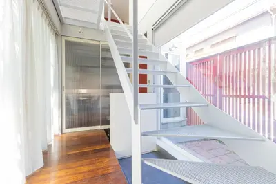 a white staircase in a room with a window at Pufuka Mukojima 1 in Tokyo