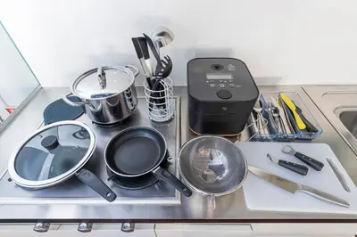 a stove top with pots and pans on it at Pufuka Mukojima 1 in Tokyo