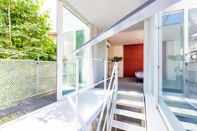 a staircase leading up to a house with large windows at Pufuka Mukojima 1 in Tokyo