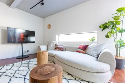a living room with a couch and a tv at Pufuka Mukojima 1 in Tokyo