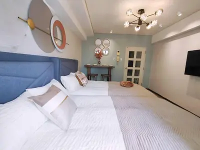 a bedroom with a large white bed with a blue headboard at S43 Shibuya center 5 mins to St, Max 4P \u6d89\u8c37\u6700\u4e2d\u5fc3 \u6d89\u8c37\u7ad95\u5206-S \u76f4\u8fbe\u8868\u53c2\u9053 \u6c60\u888b \u4e0a\u91ce \u4ee3\u4ee3\u6728 \u94f6\u5ea7 \u539f\u5bbf in Tokyo