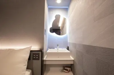 a bathroom with a sink and a mirror at inninn HOTEL UENO in Tokyo