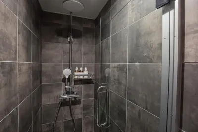 a bathroom with a shower with a glass door at inninn HOTEL UENO in Tokyo