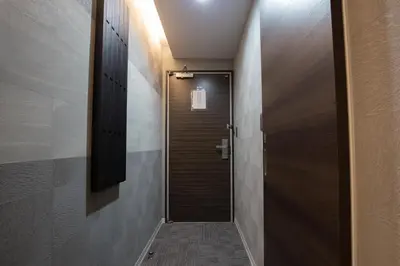 a hallway with a wooden door in a room at inninn HOTEL UENO in Tokyo