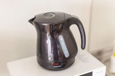 a tea kettle sitting on top of a microwave at Michiko House in Tokyo