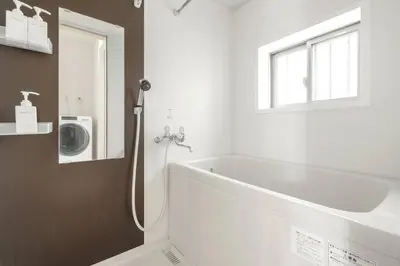 a bathroom with a bath tub and a sink at Michiko House in Tokyo