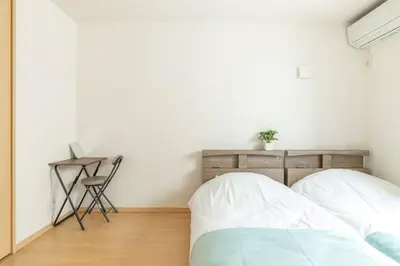a bedroom with a bed and a desk with a chair at Michiko House in Tokyo