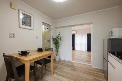 a kitchen and dining room with a table and a refrigerator at self-check in-\u65b0\u5927\u4e45\u4fdd\u30de\u30f3\u30b7\u30e7\u30f3 in Tokyo