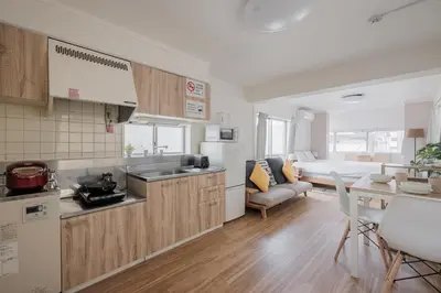 a kitchen and living room with a couch and a table at self-check in-\u65b0\u5927\u4e45\u4fdd\u30de\u30f3\u30b7\u30e7\u30f3 in Tokyo