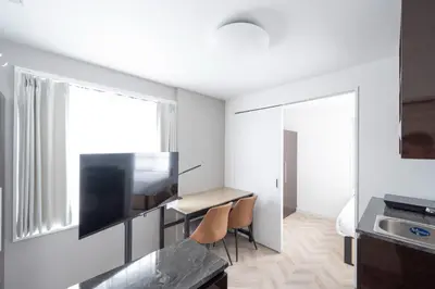 a small apartment with a desk and a television in a room at CH RESiDENCE \u559c\u4e45\u4e95\u753a in Tokyo