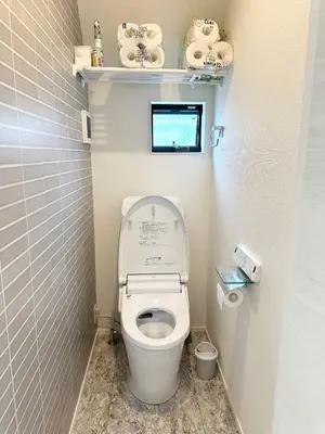 a bathroom with a toilet with a monitor above it at \u798f\u5409\u5c4b in Tokyo