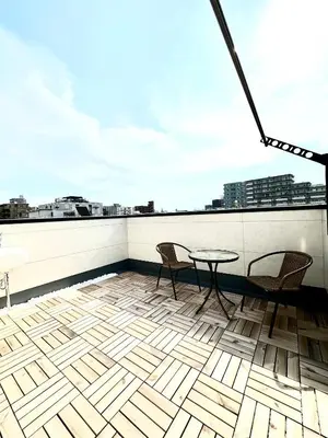 a patio with two chairs and a table on a roof at \u798f\u5409\u5c4b in Tokyo