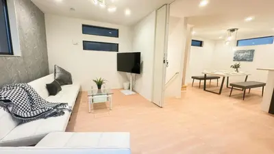 a living room with a white couch and a table at \u798f\u5409\u5c4b in Tokyo
