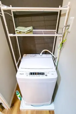 a washing machine sitting on a shelf in a room at Maru 5 Inn in Tokyo