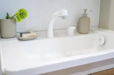a bathroom counter with a sink and a faucet at Maru 5 Inn in Tokyo