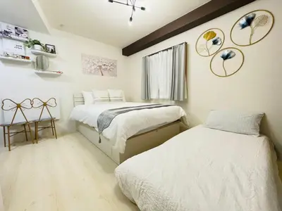 a bedroom with two beds and a window at Hyakuninchō house NEW OPEN-SJ0067 in Tokyo