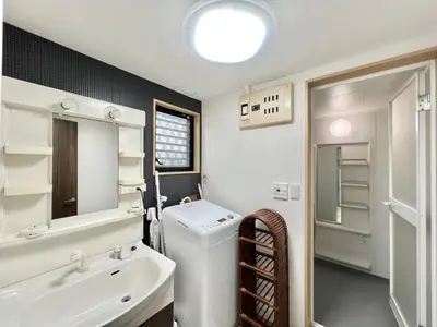 a white bathroom with a sink and a mirror at Hyakuninchō house NEW OPEN-SJ0067 in Tokyo