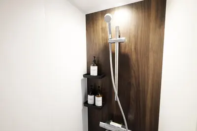a bathroom with bottles of wine on a wooden wall at \u5922\u306e\u820e\u4ee3\u3005\u6728 Yumenoya Yoyogi in Tokyo