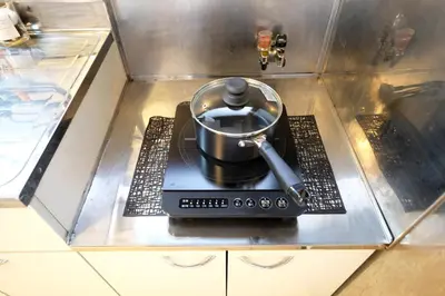 a pot on top of a stove in a kitchen at \u5922\u306e\u820e\u4ee3\u3005\u6728 Yumenoya Yoyogi in Tokyo