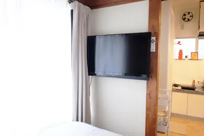 a flat screen tv on a wall in a bedroom at \u5922\u306e\u820e\u4ee3\u3005\u6728 Yumenoya Yoyogi in Tokyo