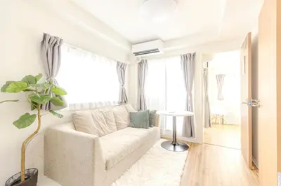 a living room with a white couch and a window at a\u5c71\u624b\u7dda\u99d2\u8fbc7\u52064LDK\u30de\u30f3\u30b7\u30e7\u30f391\u5e73\u65b9\u30e1\u30fc\u30c8\u30eb in Tokyo
