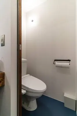 a bathroom with a white toilet in a room at Rakuna Inn \u904a Kinshicho in Tokyo