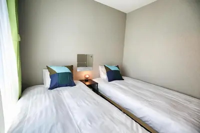 two beds sitting next to each other in a room at QU302 Edogawa Japanese Style has direct access to Akihabara and Shinjuku, with convenient free WiFi in Tokyo