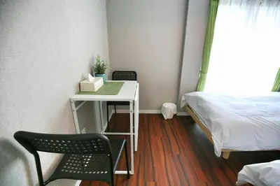 a small room with a bed and a table and a bed at QU302 Edogawa Japanese Style has direct access to Akihabara and Shinjuku, with convenient free WiFi in Tokyo