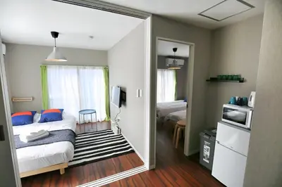 a bedroom with a bed and a door leading into a room at QU302 Edogawa Japanese Style has direct access to Akihabara and Shinjuku, with convenient free WiFi in Tokyo