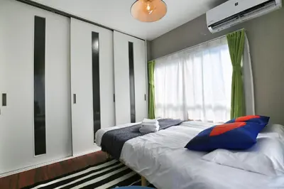 a bedroom with a large bed and a window at QU302 Edogawa Japanese Style has direct access to Akihabara and Shinjuku, with convenient free WiFi in Tokyo