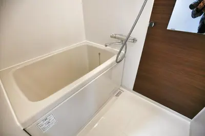 a bath tub in a bathroom with a door at QU302 Edogawa Japanese Style has direct access to Akihabara and Shinjuku, with convenient free WiFi in Tokyo
