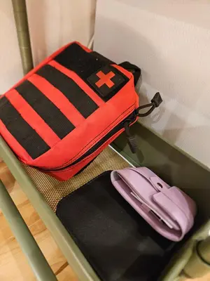 a red and black bag sitting on a shelf at Asakusa Stay in Tokyo