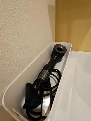 a black bottle is in a white container at Asakusa Stay in Tokyo