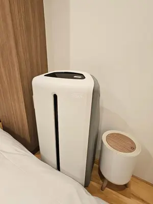 a white and gray toilet next to a bed at Asakusa Stay in Tokyo