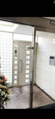 a glass door in a building with a elevator at \u65b0\u5bbf\u5ead\u9662\u306e\u5c4b-Shinjuku Garden Home -28 square meters king size bed garden room105 in Tokyo