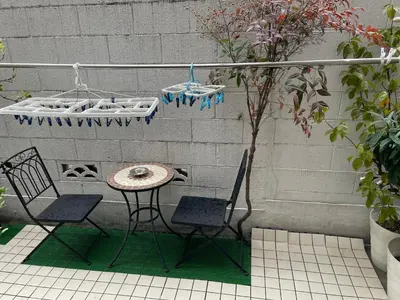 a patio with two chairs and a table and a table at \u65b0\u5bbf\u5ead\u9662\u306e\u5c4b-Shinjuku Garden Home -28 square meters king size bed garden room105 in Tokyo