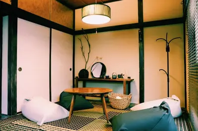 a room with a table and two pillows at #11 -\u5e61\u30f6\u8c37 \u6cc9\u5eb5- \u53e4\u6c11\u5bb6\u306e\u5bbf in Tokyo