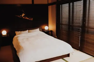 a bedroom with a white bed and a window at #11 -\u5e61\u30f6\u8c37 \u6cc9\u5eb5- \u53e4\u6c11\u5bb6\u306e\u5bbf in Tokyo