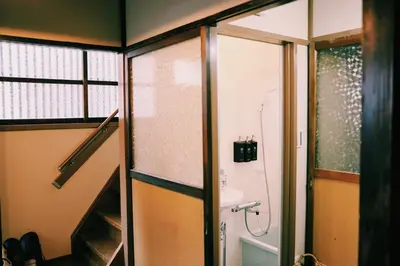 a bathroom with a shower and a sink and a toilet at #11 -\u5e61\u30f6\u8c37 \u6cc9\u5eb5- \u53e4\u6c11\u5bb6\u306e\u5bbf in Tokyo