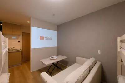 a living room with a couch and a table at TD Stay Tokyo in Tokyo