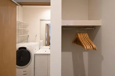 a bathroom with a washing machine and a washer at TD Stay Tokyo in Tokyo