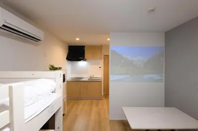 a small room with a bed and a kitchen at TD Stay Tokyo in Tokyo