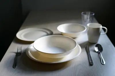 a table with three white plates and forks and spoons at TD Stay Tokyo in Tokyo