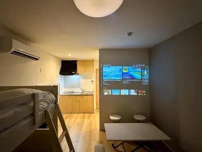 a small room with a bed and a kitchen at TD Stay Tokyo in Tokyo