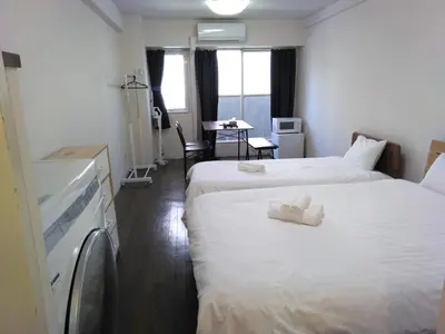 a hotel room with two beds with towels on them at \u85e4\u548c\u30a8\u30af\u30b7\u30fc\u30eb\u9053\u7384\u5742d in Tokyo
