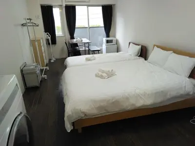 a hotel room with two beds with towels on them at \u85e4\u548c\u30a8\u30af\u30b7\u30fc\u30eb\u9053\u7384\u5742d in Tokyo