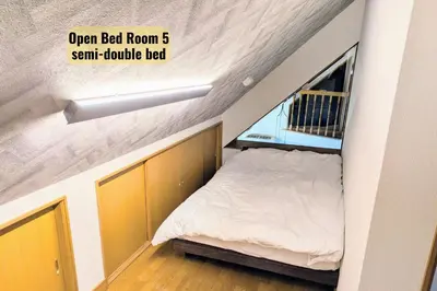 a small bedroom with a bed in the attic at Hotel Iemirai Nakano Penthouse - SHINJUKU 12min train ride in Tokyo