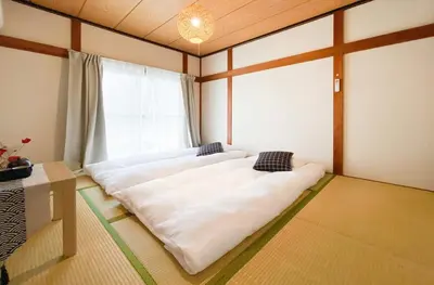 a room with two beds in front of a window at New Super Deals Now Available Direct Access to Akihabara Shinjuku and Disneyland in Tokyo