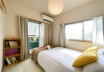 a bedroom with two beds and a window at New Super Deals Now Available Direct Access to Akihabara Shinjuku and Disneyland in Tokyo